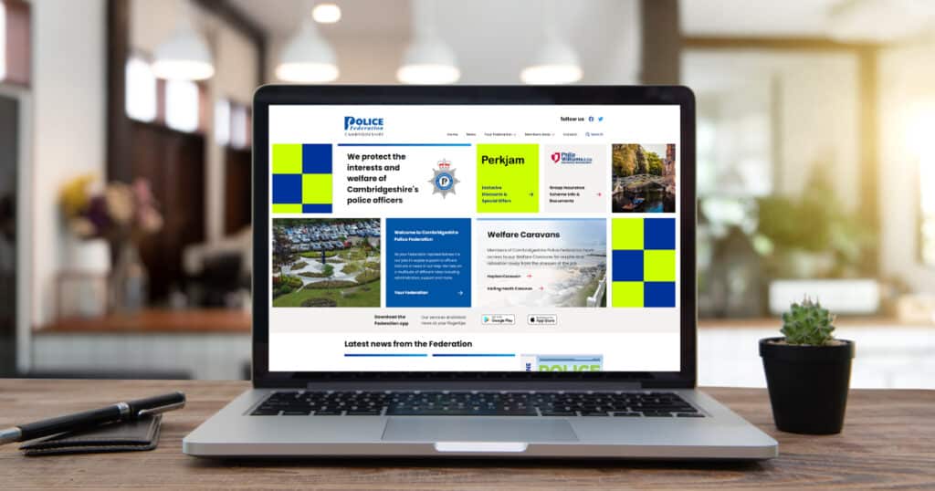 Cambridgeshire Police Federation website home page design on laptop, which sits on desk
